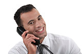 Businessman using land-line telephone