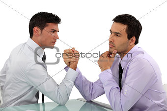 handsome businessmen arm wrestling