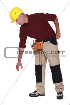 Construction worker reaching down to empty copyspace