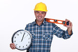carpenter all smiles holding ruler and clock