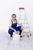 Worker with paint, brush and ladder