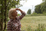 A mature woman looking over the fields