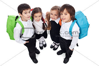 Happy school kids with back packs