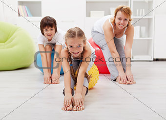Happy family doing stretching exercises at home