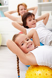 Kids exercising with their mother