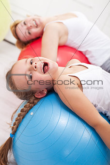 Happy exercising - little girl and her mother