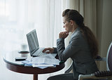 Thoughtful business woman working in hotel room