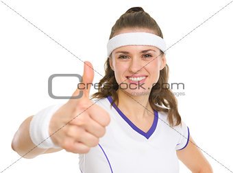 Portrait of smiling tennis player showing thumbs up