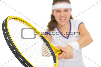 Closeup on racket in hand of tennis player reflecting strike