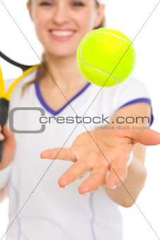 Closeup on ball throwing up in air by tennis player
