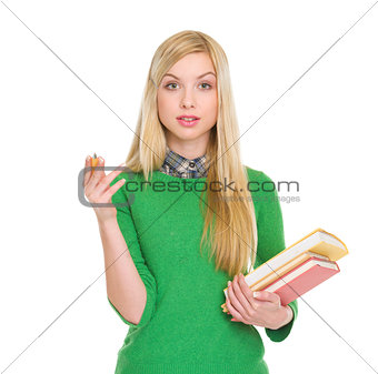 Portrait of exited student girl with books