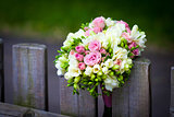 Wedding bouquet on rustic country fence 