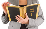 Woman in business suit is reading a holy bible