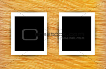 Two photo frames on abstract wooden background