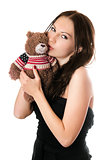 Young woman kissing teddy-bear