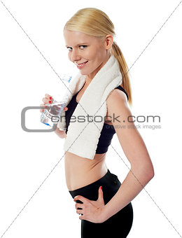 Fit female athlete holding a bottle of water