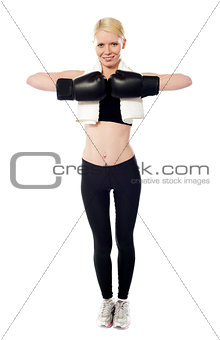 Happy female boxer posing with gloves on