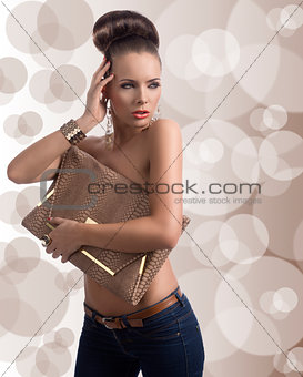 fashion brunette in jeans with big bag and hand near the head