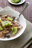 Breakfast cereals with milk and kiwi