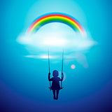 Little girl on a swing under rainbow in a clouds