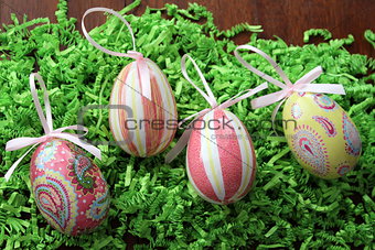Decoupage easter eggs on grass