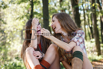 two girlfriends outdoor laughing