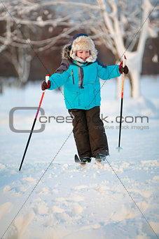 Cute little boy having fun during skiing on cross