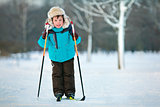 Cute five years old boy skiing on cross