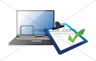 laptop and clipboard with checkmark