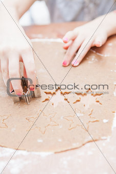 Cutting gingerbread shapes from dough