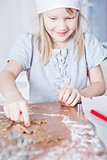 Young girl pointing to gingerbread shape