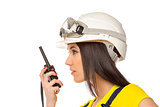 Serious female construction worker talking with a walkie talkie 