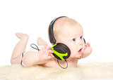 Portrait of 6 month old boy with headphones, isolated on white