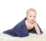 Adorable happy baby in colorful towel