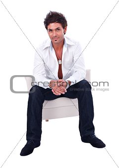 Handsome man sitting in armchair