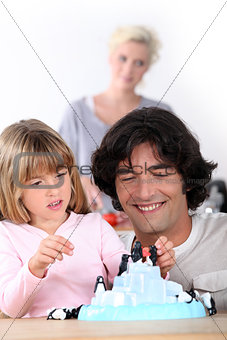 a father playing with his daughter