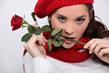 Brunette with rose in her mouth