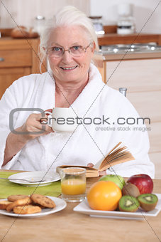 Senior woman having a relaxed breakfast