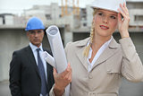 Female architect on site holding her hard hat