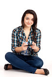 Teenage girl sitting and playing games