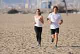 Man and woman running on the beach