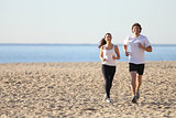 Man and woman running in the beach