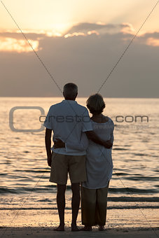 Senior Couple Embracing Sunset Tropical Beach