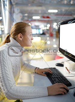 Young girl and blank monitor.