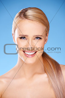 Beautiful girl with big smile on blue
