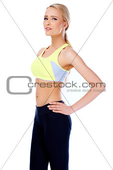Sexy and slim blond woman standing on white