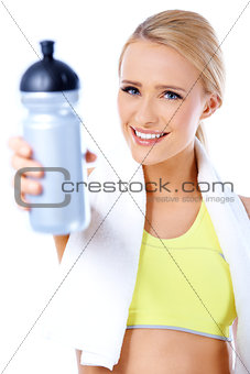 Cute sporty blond woman holding water bottle