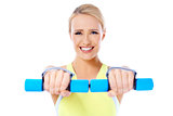 Close up of fit woman while exercise with dumbbells