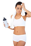 Tired woman after fitness with water bottle