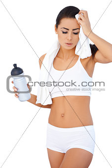 Tired woman after fitness with water bottle